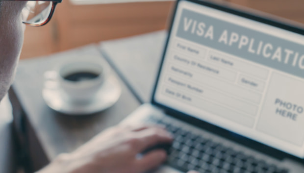 Person filling out a visa application form