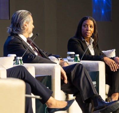 Panel speakers interact on stage at MEOS GEO 2023