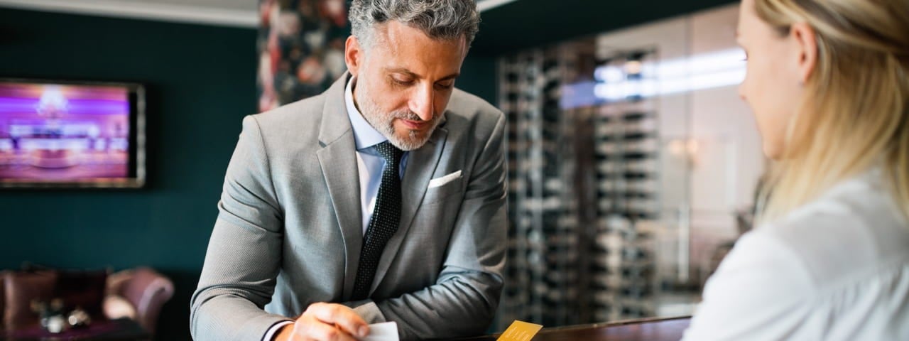 A man booking a hotel room.