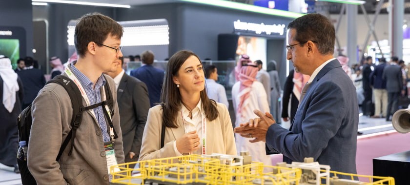 Visitors speak to an exhibitor at MEOS GEO 2023